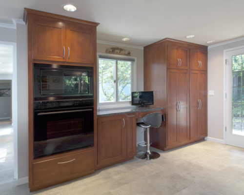 The beautiful double ovens and built-in desk area