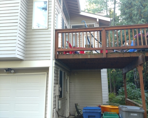 The deck and garbage and recycling can area