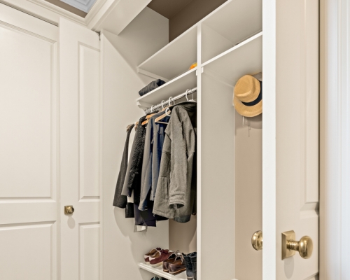 The newly remodeled entry closet with specialty European hinges that pivot 90 degrees